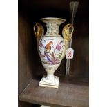A 19th century Bloor Derby twin handled vase, finely painted to both sides with exotic birds, and