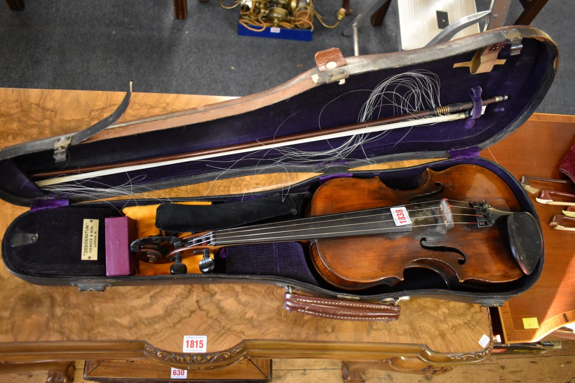 An antique Continental violin, with 14in single piece back, with bow, in Hawkes & Son case.