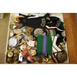 A collection of military buttons and badges; and others.