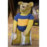 An early 20th century straw filled hump back growler teddy bear in golden mohair, possibly Steiff,