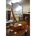 A George III mahogany serpentine base toilet mirror, 53cm wide.