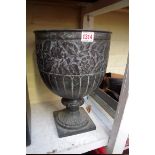 A verdigris metal pedestal urn, repousse decorated with floral scrolls, 34.5cm high.