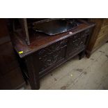 A 17th century carved oak panelled coffer, 110cm wide.