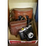 A pair of Wray 'Raylight' 8x30 binoculars, in leather case; together with a Zeiss Ikon camera, in