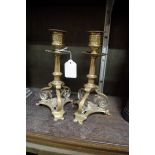 A pair of antique brass candlesticks, 21cm high.