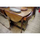 An unusual George III mahogany Pembroke table, the frieze drawer with three fitted caddies, on