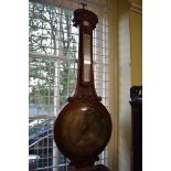 A Victorian mahogany banjo barometer, the 10in silvered dial inscribed 'Wilson, Chichester'.
