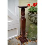 An old carved mahogany torchere.