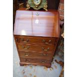 A small reproduction mahogany bureau, 53cm wide.