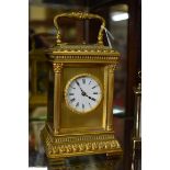 A good gilt brass carriage clock, with push button repeat and gong strike, height including handle