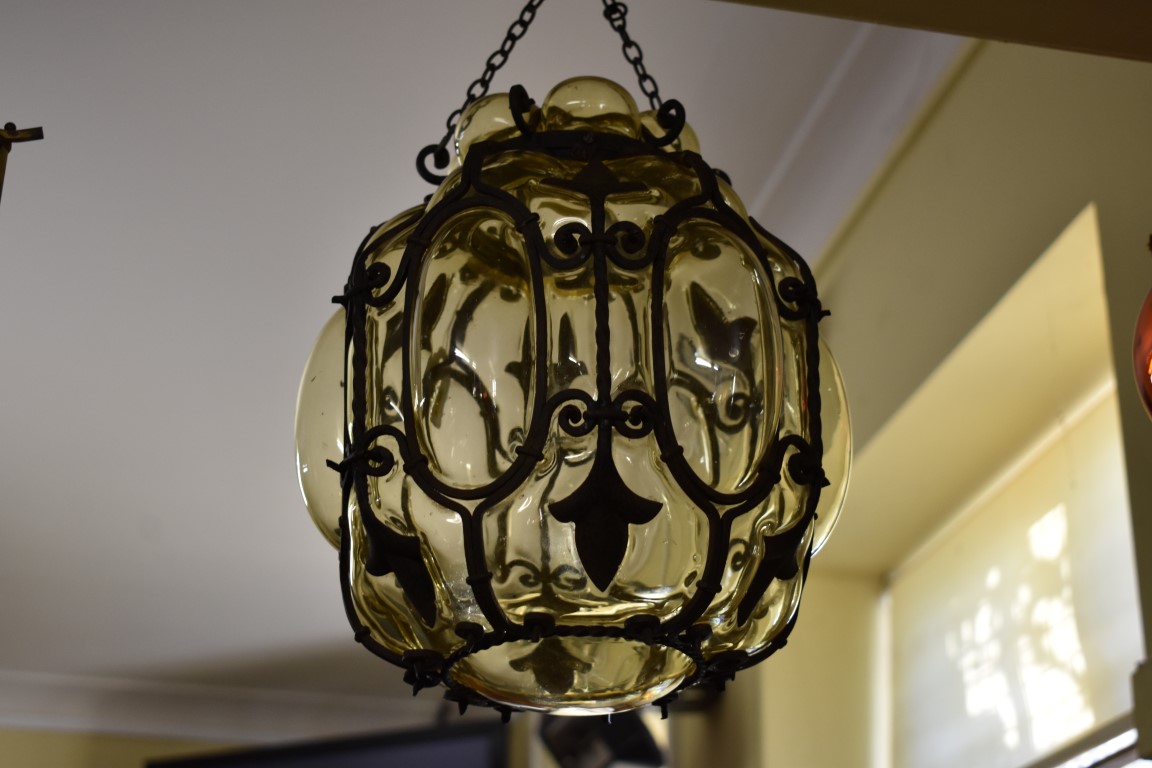 A glass and wrought iron hanging lantern, 32cm high.