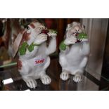 A rare pair of Continental porcelain long eared rabbits, 18/19th century, 15.5cm high, (one s.d.).