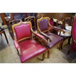 A set of five Victorian Gothic oak dining chairs, to include a pair of elbow chairs.