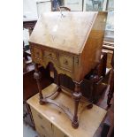 A small reproduction walnut and crossbanded bureau on stand, 48.5cm wide.