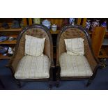 A pair of Regency simulated rosewood and cane bergere tub chairs.