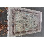 An Oriental rug, having beige field with allover floral design, 195 x 120cm.