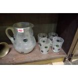 A Continental iridescent glass lemonade jug and four beakers, the jug 20cm high.
