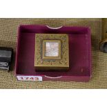 An antique brass stamp box.