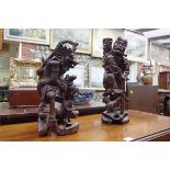 Two Eastern carved hardwood figures, largest 43.5cm high.