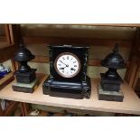 A slate and marble mantel clock, 22cm high; together with a pair of slate and green onyx side urns.