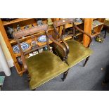 A pair of Regency mahogany elbow dining chairs.