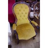 A Victorian rosewood and button upholstered open arm occasional chair.