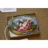 A late 18th/early 19th century Continental enamel oval plaque of cupid and two doves, 6.5cm wide, in