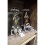 Two bronze cherub and crocodile figural candlesticks, 21.5cm high.