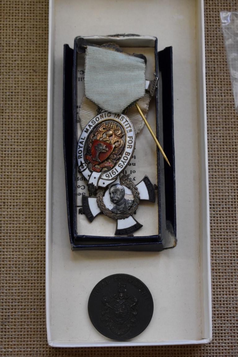 Two silver and enamel masonic medals; together with a Royal Tournament medal.