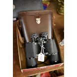 A pair of Dollond 10x50 binoculars, in leather case.