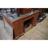 A reproduction walnut pedestal desk, 124.5cm wide.