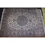 A Persian rug, having central floral medallion, with allover floral field on a cream and beige