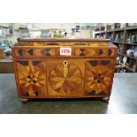 An early 19th century marquetry tea caddy, indistinctly labelled to base, 31cm wide.