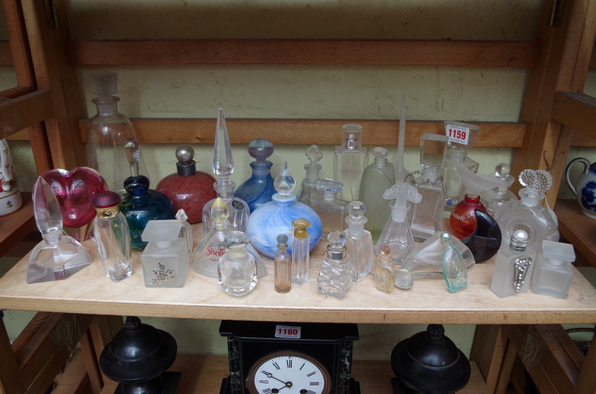 A collection of clear and coloured glass scent bottles and stoppers.