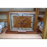 A 1930s walnut mantel clock, 33cm wide, (lacking pendulum bob).