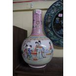 A Chinese famille rose bottle vase, 32cm high, (restored).