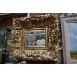 A reproduction gilt framed wall mirror, 47 x 52cm.