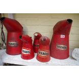 Five Texaco oil cans.
