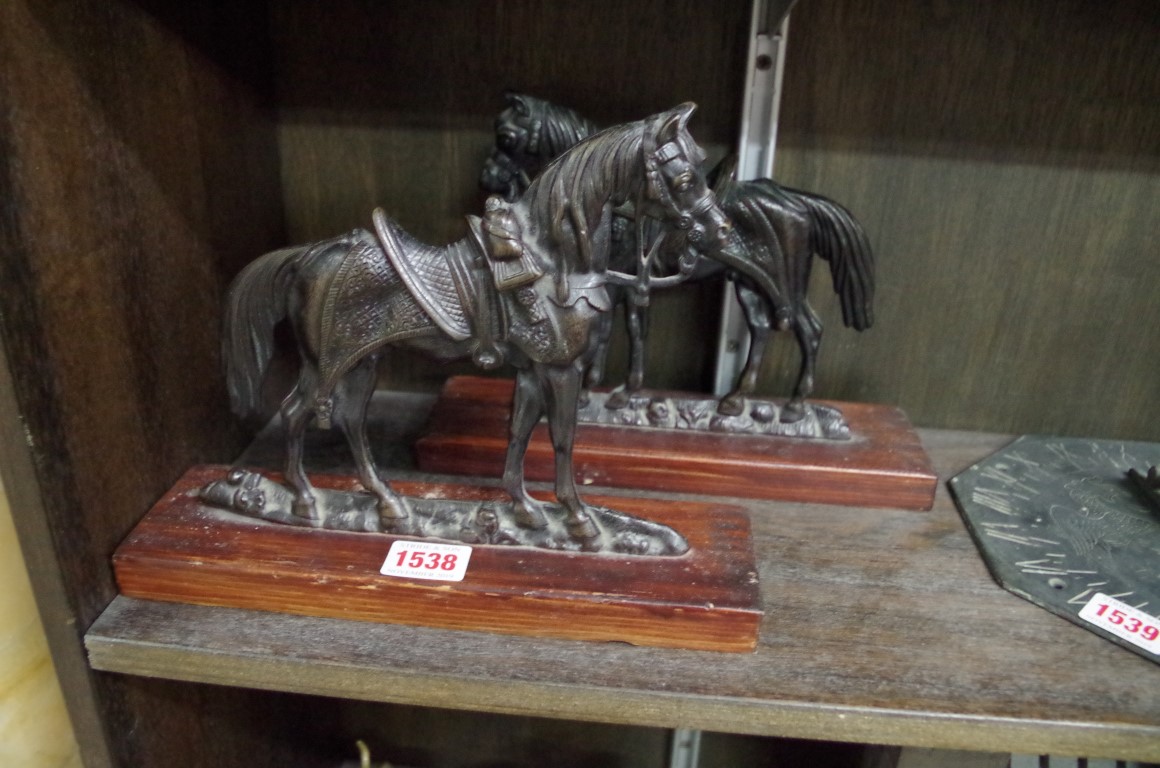 A pair of bronze flatback horses, one stamped 'Crowley & Co, Manchester', 16cm high, on wood stands.