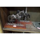 A pair of bronze flatback horses, one stamped 'Crowley & Co, Manchester', 16cm high, on wood stands.