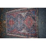 An Eastern rug, having three central medallions, with floral central field and geometric borders,