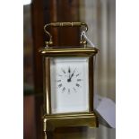 An old brass miniature carriage timepiece, height including handle 10.5cm.