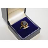 A smokey quartz unmarked yellow metal dress ring, tested as 9ct.