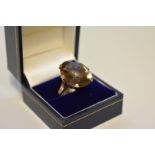 A large smokey quartz gold ring, stamped 9ct, approximately 22ct.