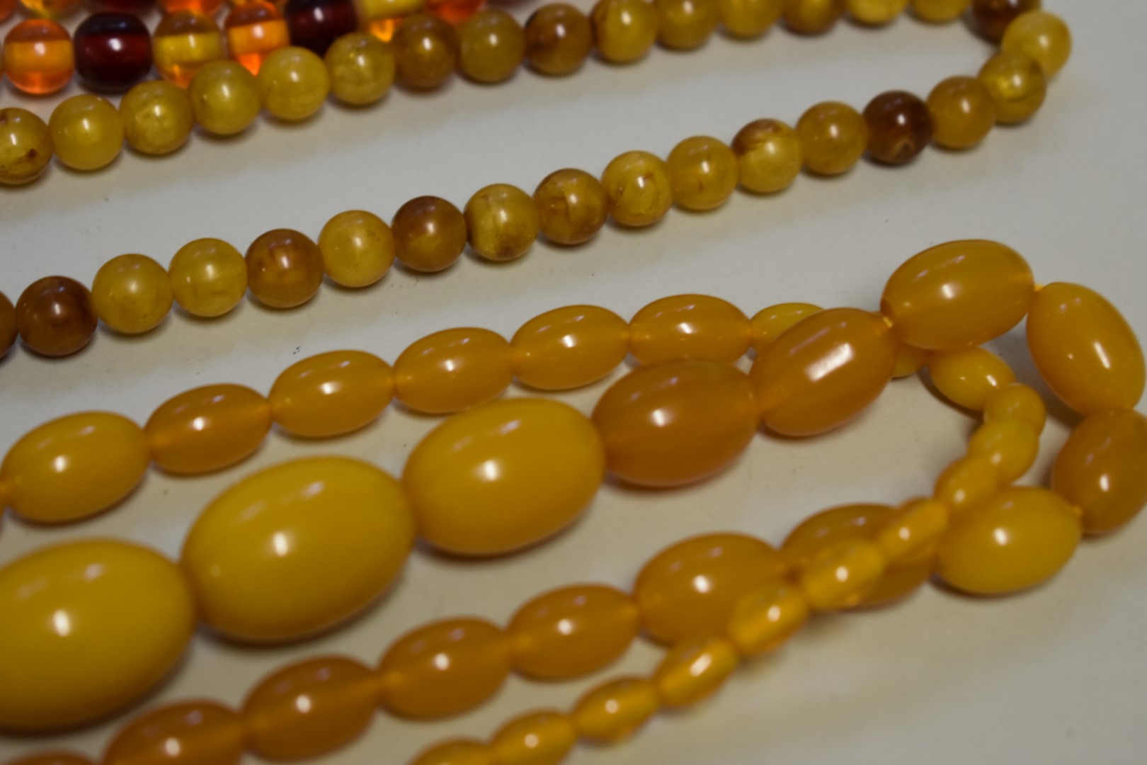 Three strings of amber coloured beads. - Image 3 of 3