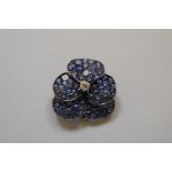 A sapphire and diamond encrusted 'pansy' pendant brooch, set in unmarked yellow metal, 27mm, 9.6g