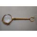 A French yellow metal lorgnette, stamped with eagle head mark for 18k, 12.5cm long.