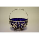 A Victorian pierced silver basket, by Goldsmiths & Silversmiths Co, London 1896, having blue glass