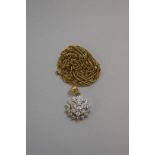 A diamond cluster gold pendant, stamped 9k, 8cm diameter, 4.5g total weight; together with a metal