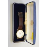 A Garrard gold plated manual wind wristwatch, 32mm, case no 8410, on leather strap, (engraved